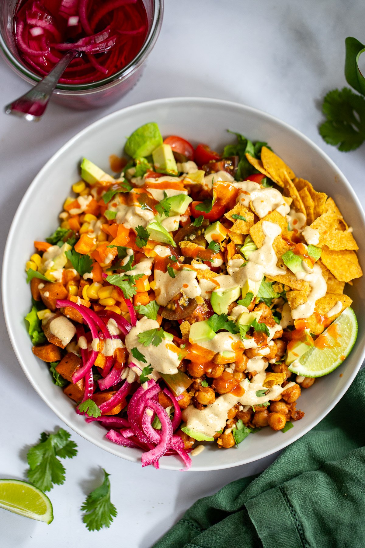 chickpea taco salad in a bowl topped with creamy cashew dressing.