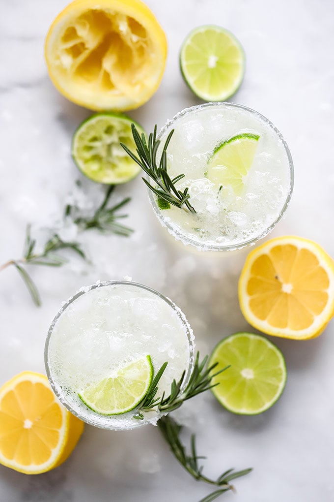 rosemary margarita in glass with salt on rim. 