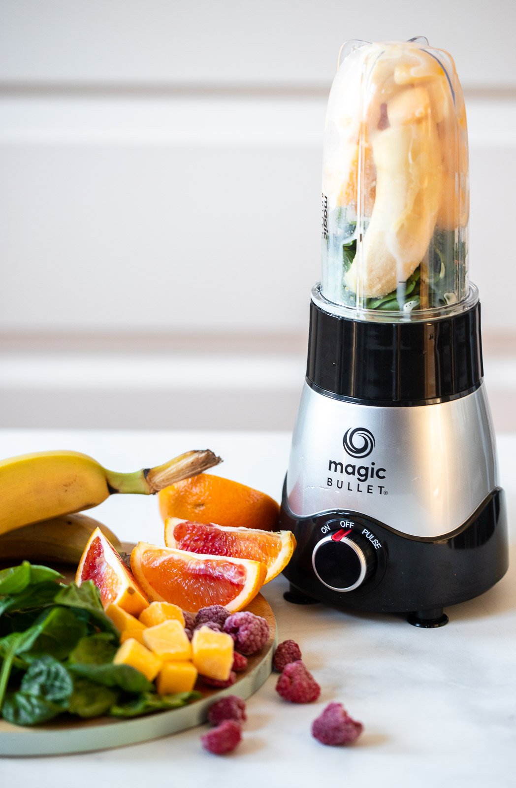 magic bullet blender and plate of fruit