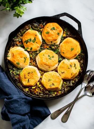 vegan lentil pot pie with biscuit topping in cast iron skillet.