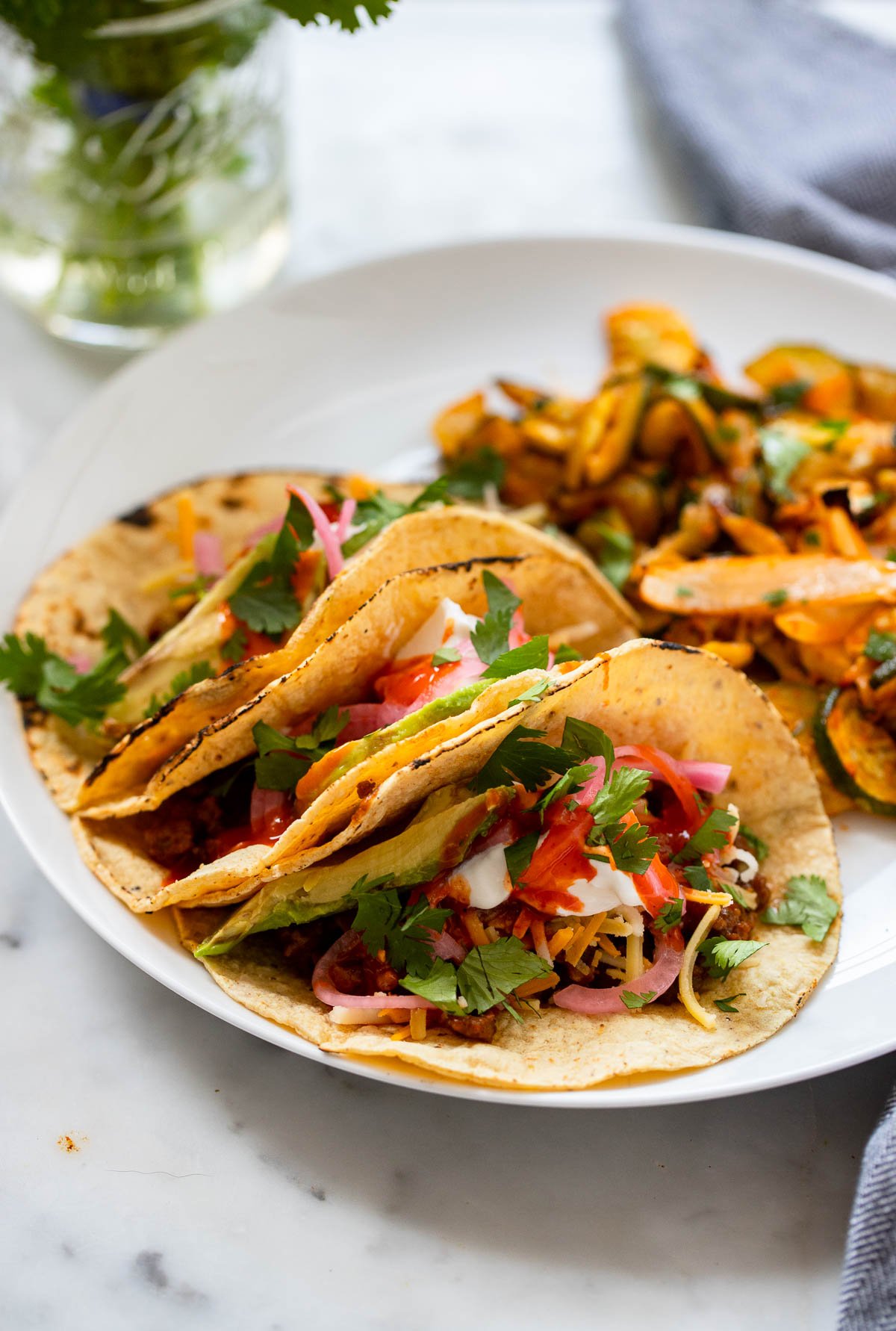 easy vegan tacos on plate with cooked zucchini.