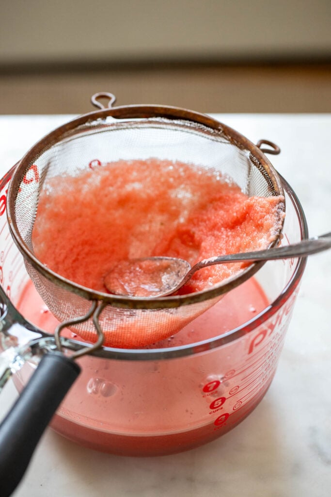strain margarita through fine mesh strainer into bowl. 