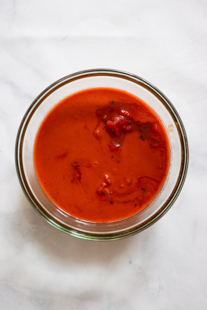 mix enchilada sauce and tomatoes in bowl.
