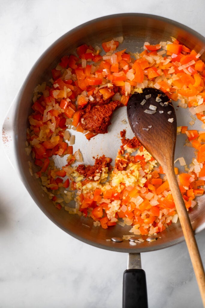 Stir in the garlic, ginger, and curry paste to the pan and cook for 1-2 minutes.
