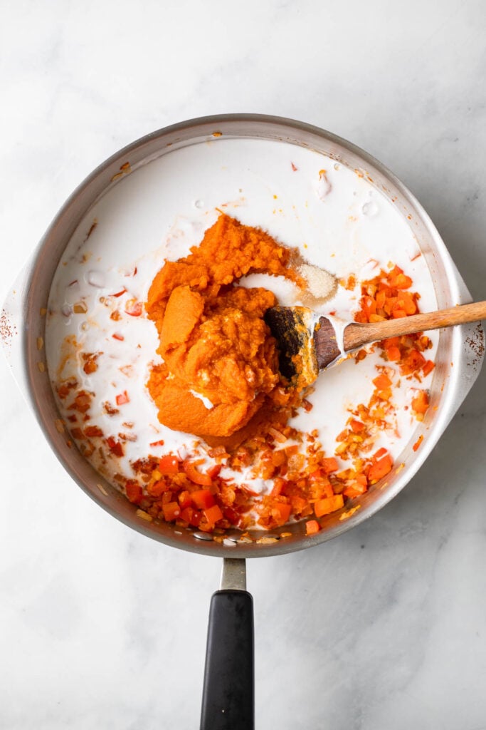 add the coconut milk and pumpkin to the pan.