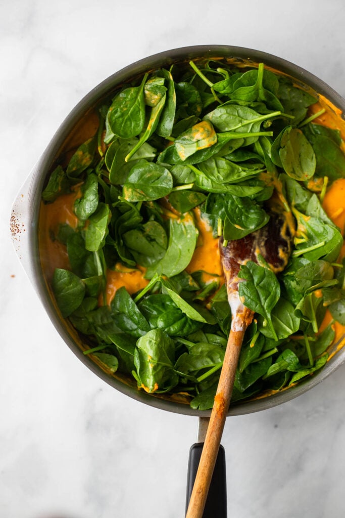 add spinach and tofu to the pan and cook until spinach is wilted.
