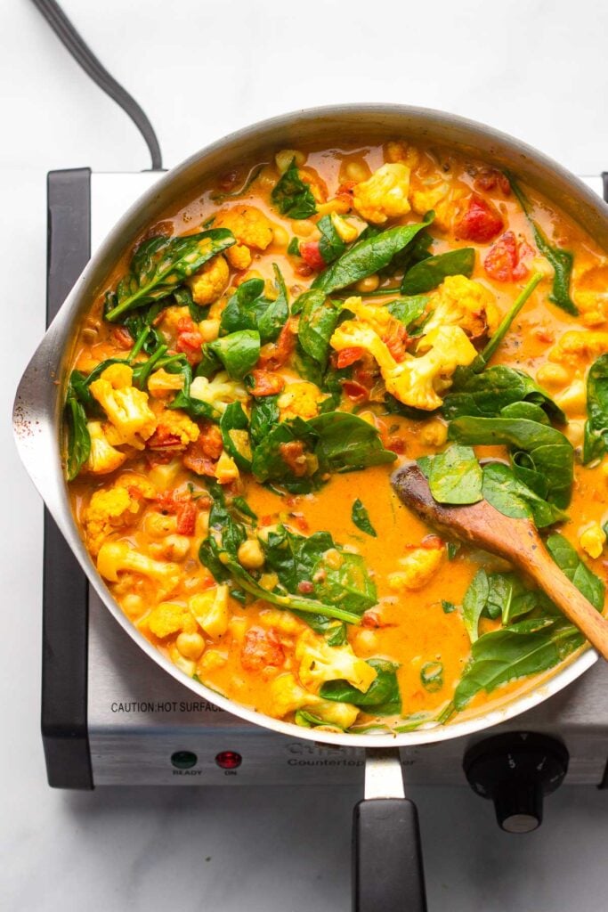 add the spinach and chickpeas to the skillet and simmer until spinach is wilted.