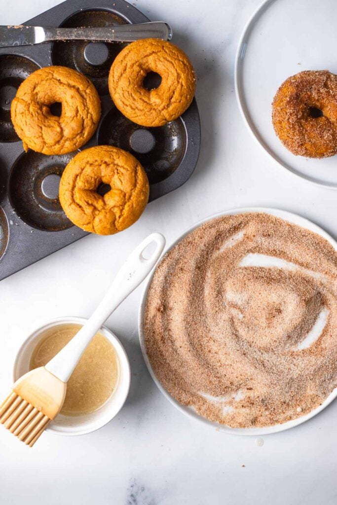 Brush donuts with melted butter and roll in cinnamon sugar.