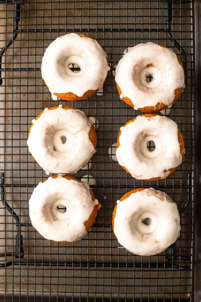 Drizzle glaze over donuts with a spoon.