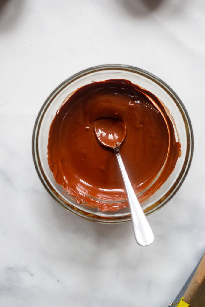 melted chocolate and peanut butter stirred together in a small mixing bowl.