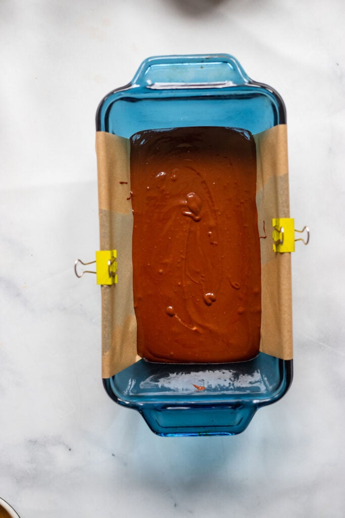 fudge mixture poured into a parchment lined loaf pan.