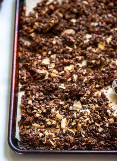 baked and cooled granola broken into chunks on a baking sheet.