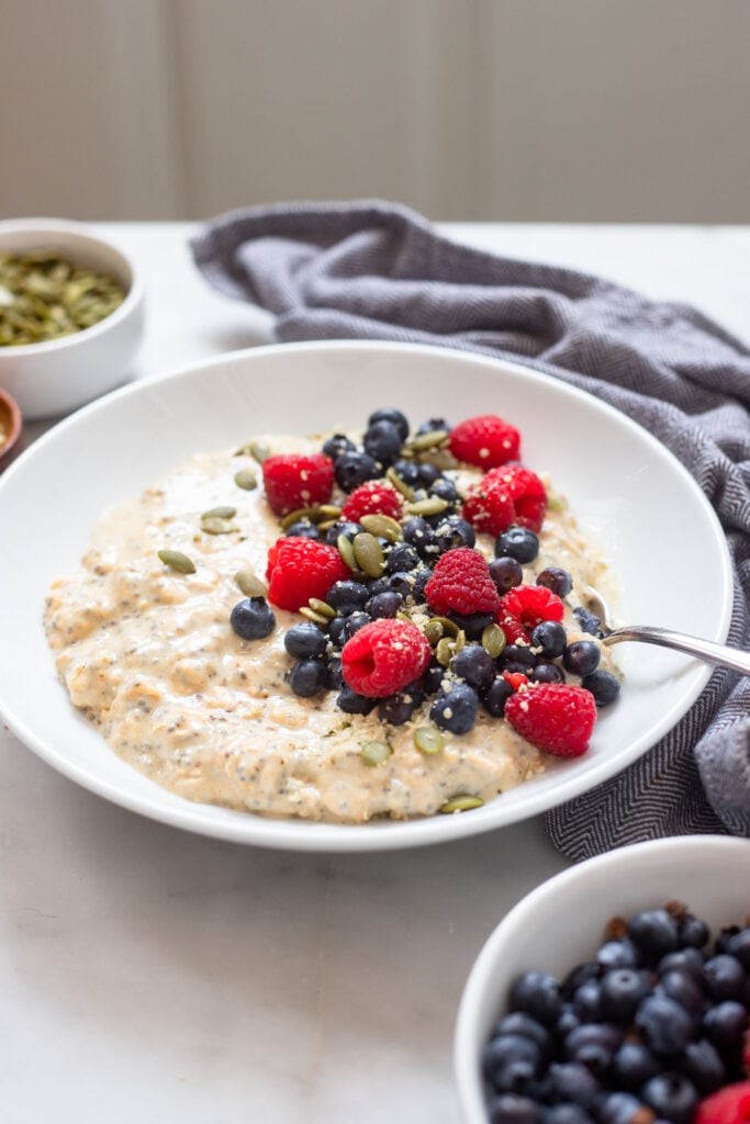overnight oats in bowl garnished with fresh berries. 