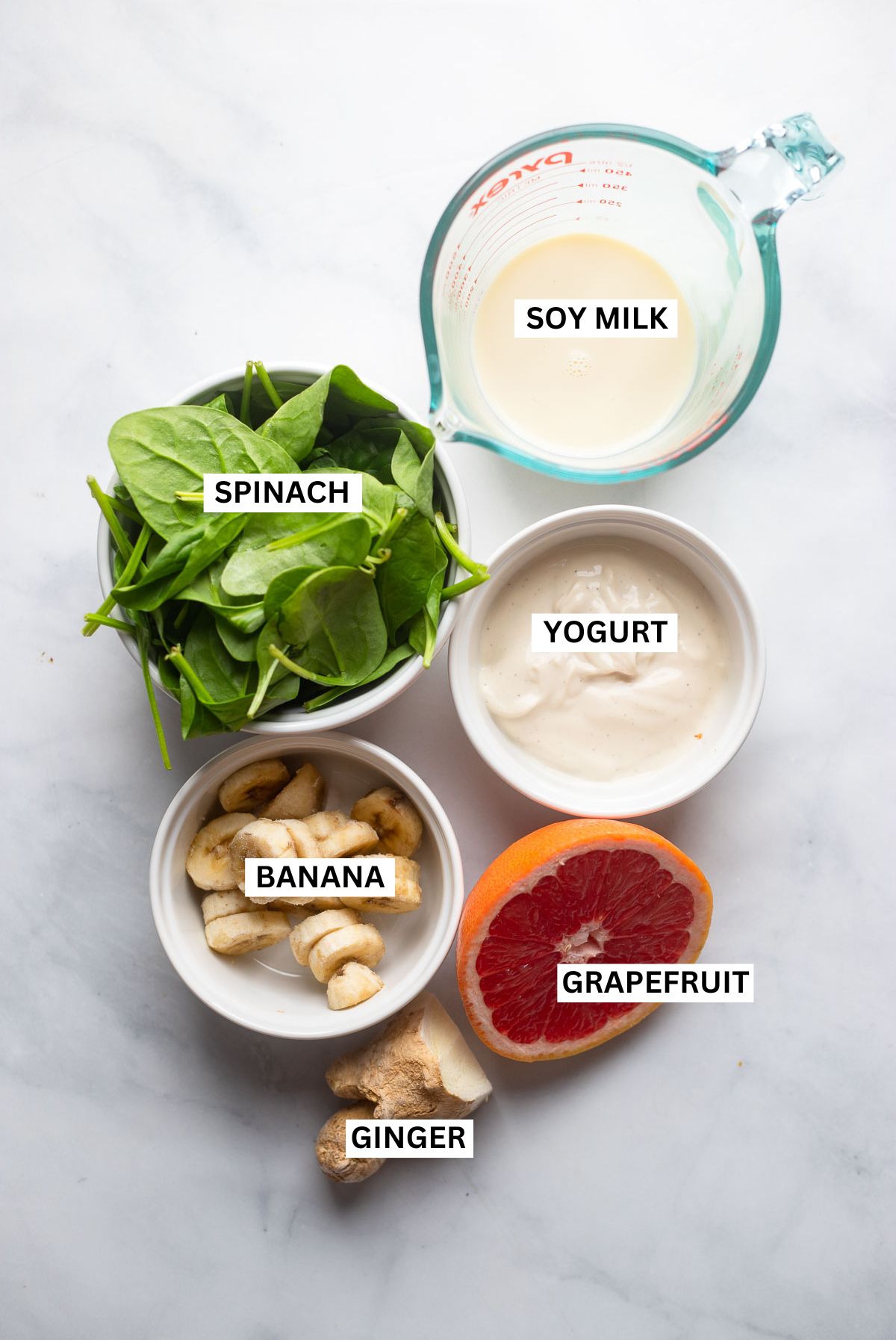 grapefruit green smoothie ingredients in small bowls with labels.
