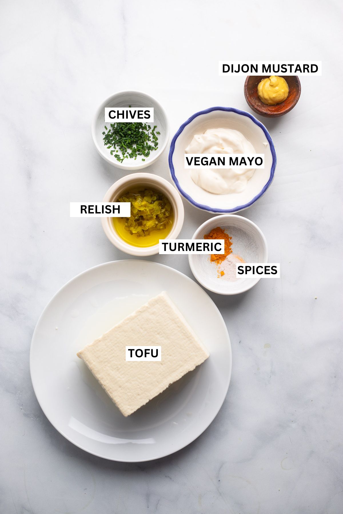 vegan tofu egg salad ingredients in small bowls with labels. 