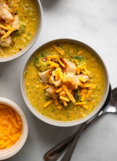 vegan broccoli cheddar soup in bowl garnished with croutons.