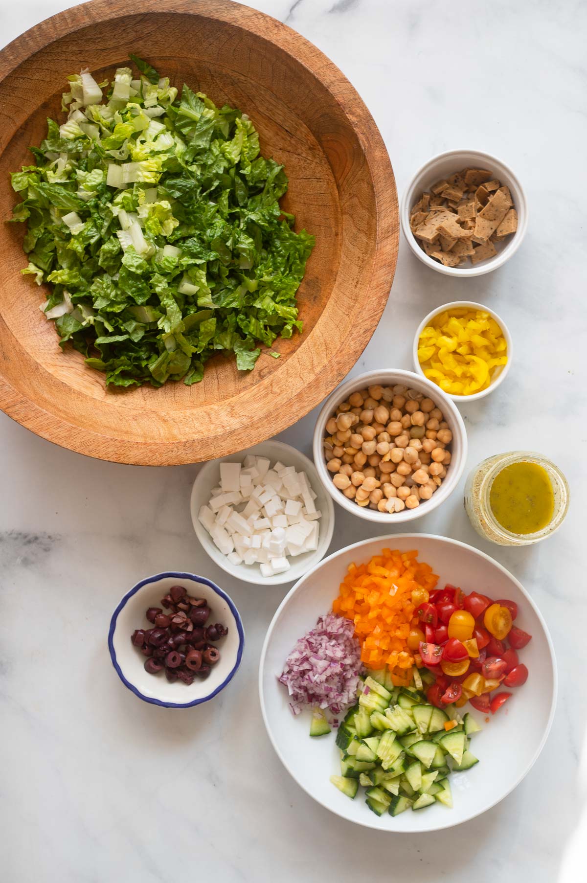 Italian chopped salad ingredients assembled in small bowls. 