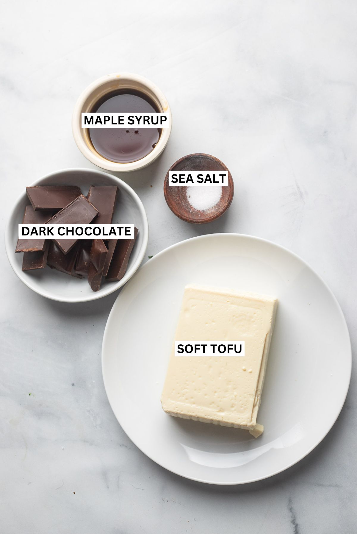 chocolate tofu mousse ingredients in bowls with text overlay that says: soft tofu, chocolate, maple syrup, and sea salt.