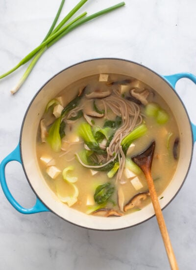 dutch oven with cooked miso soup, soba noodles, and veggies. 