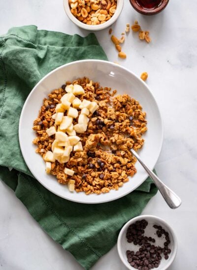 peanut butter granola in a bowl with chopped banana.