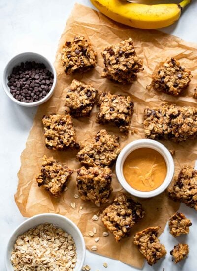 peanut butter banana oatmeal bars cut into squares on parchment paper.
