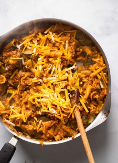 taco skillet with the noodles cooked into the rest of the ingredients with shredded vegan cheese on top.