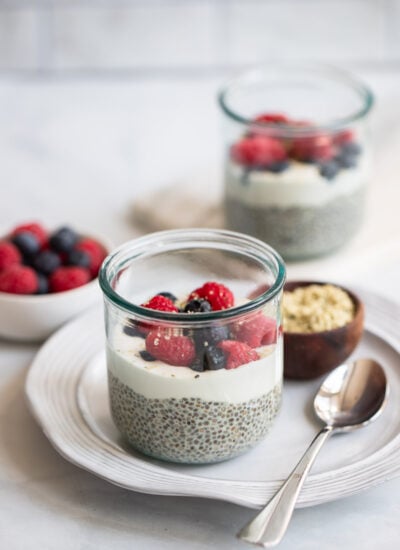 vanilla chia seed pudding topped with berries in a glass.