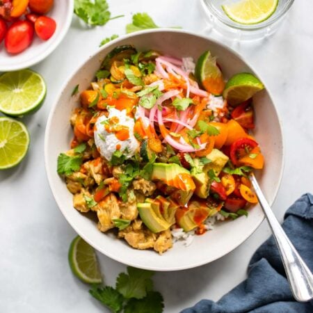 vegan Tex Mex bowl dished out and garnished with fresh cilantro and hot sauce.