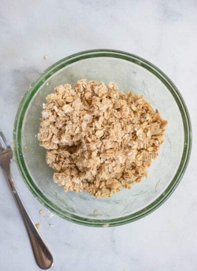 peach crisp oat topping mixed together in a medium bowl. 