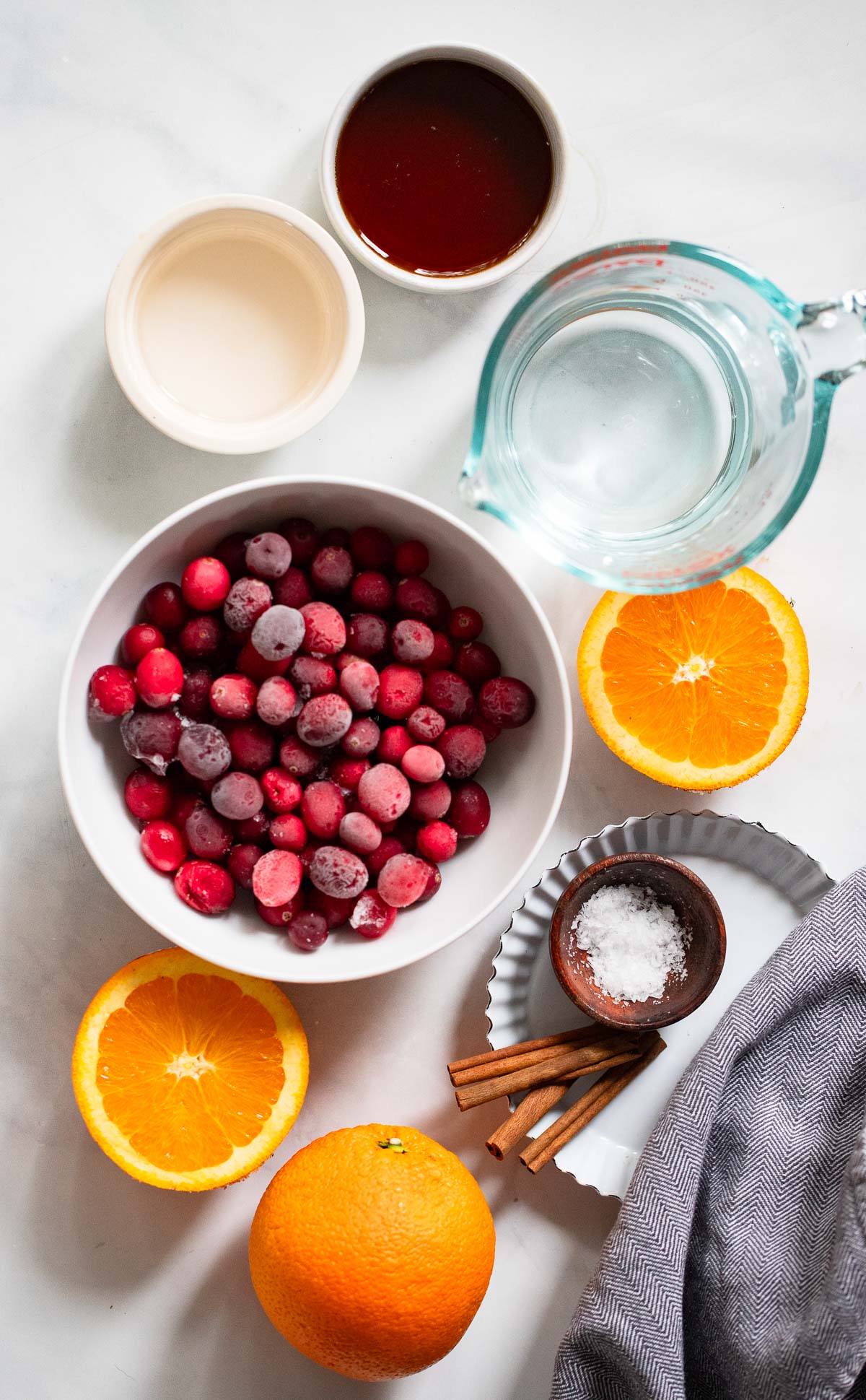 cranberry sauce ingredients in small bowls on a white background.