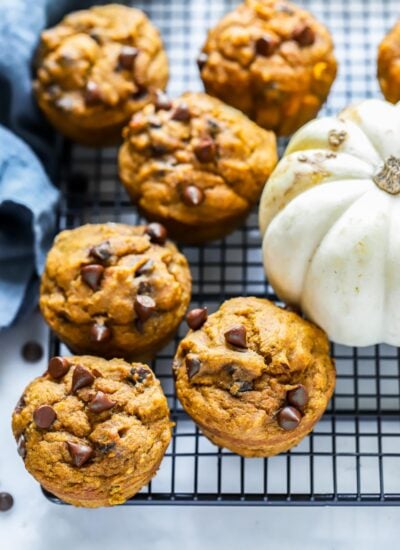 vegan pumpkin chocolate chip muffins on a cooling rack.