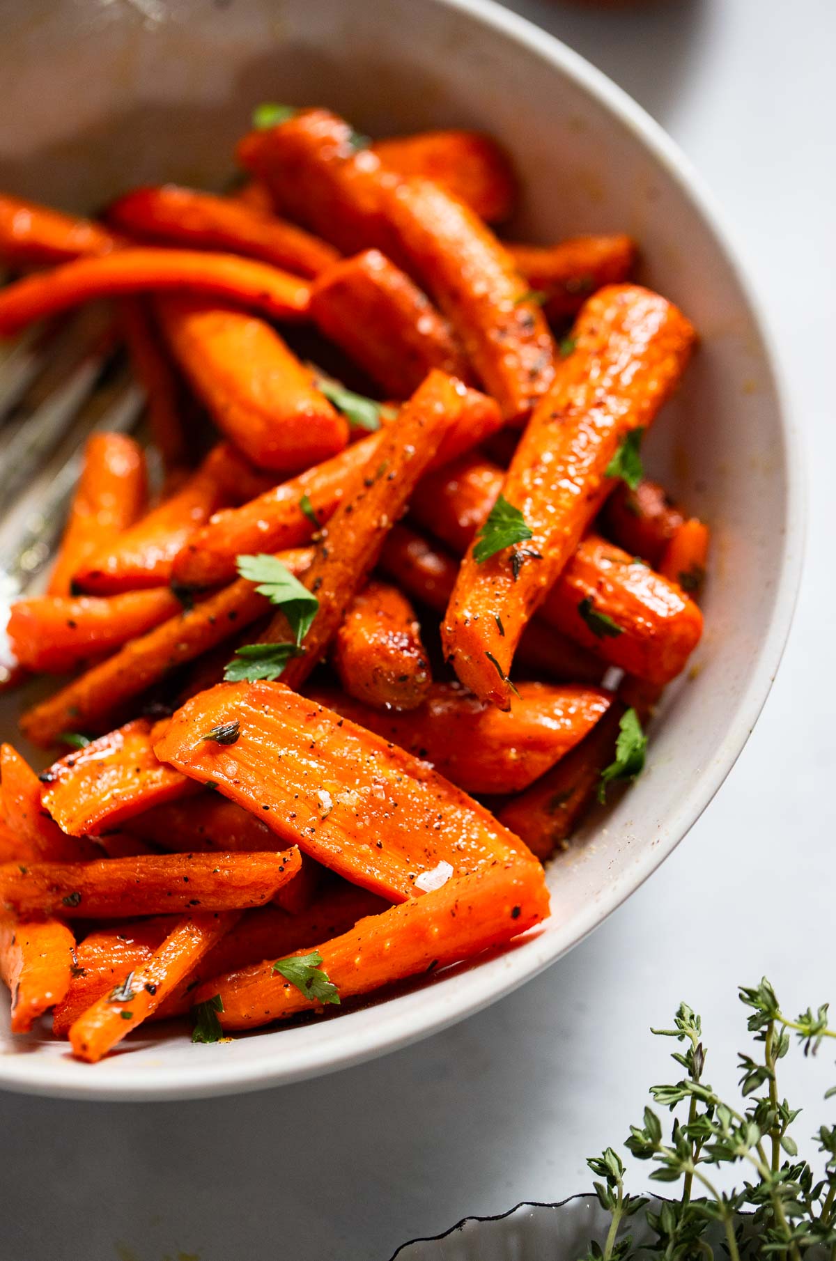 oven roasted carrots in a white serving bowl.