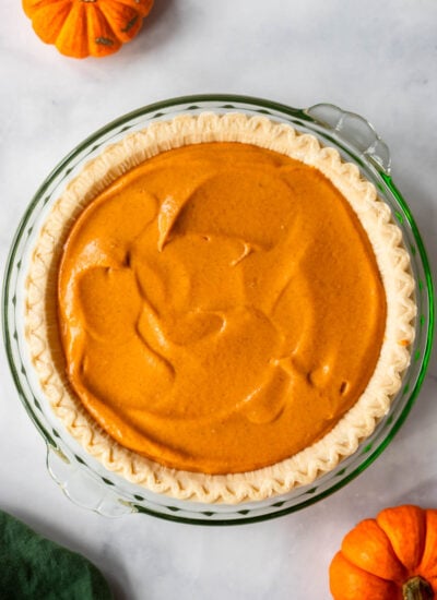 pumpkin pie filling in a pie crust before baking. 