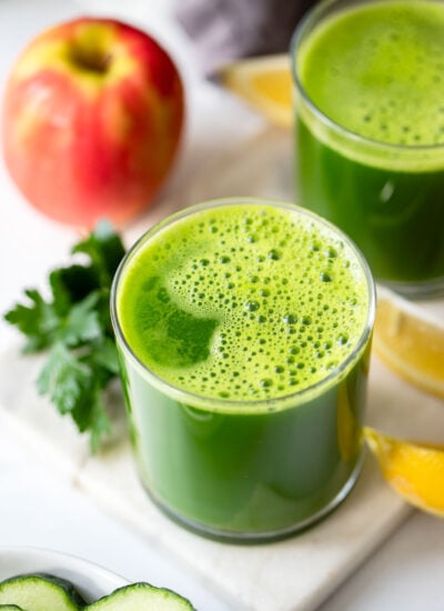 blender green juice in a glass on a white background.