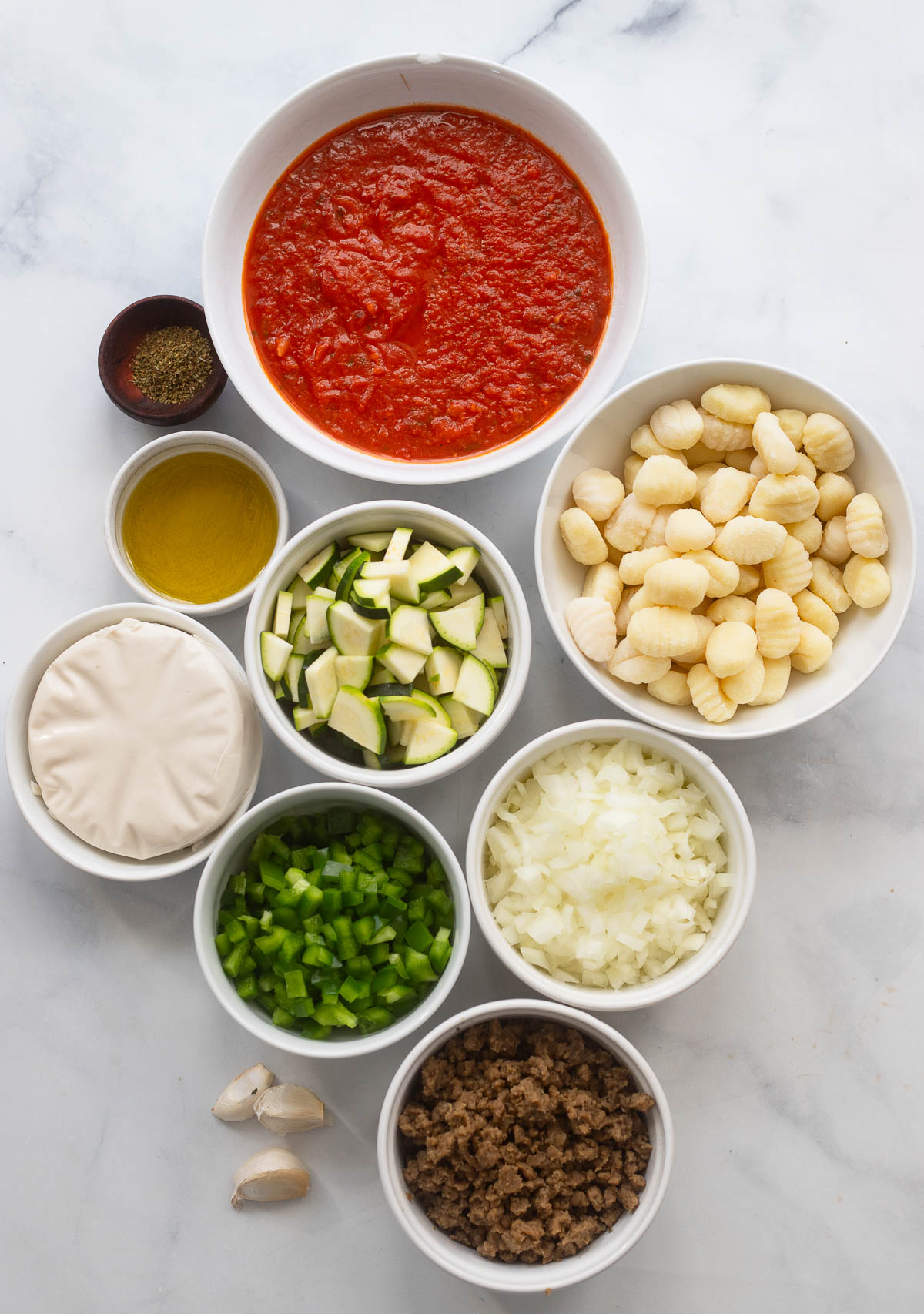 easy gnocchi skillet ingredients in bowls on a white background. 
