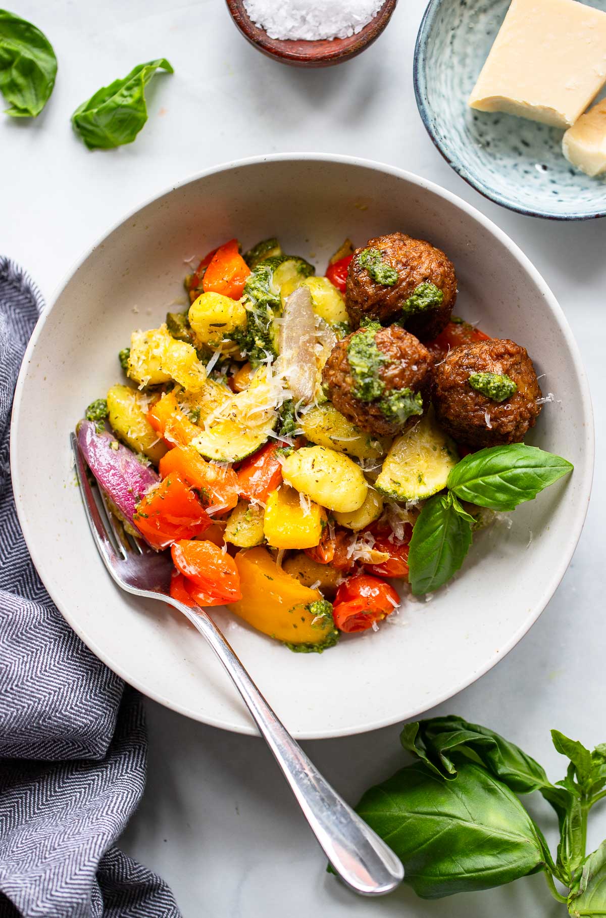 a serving of sheet pan gnocchi in a bowl with veggie meatballs. 