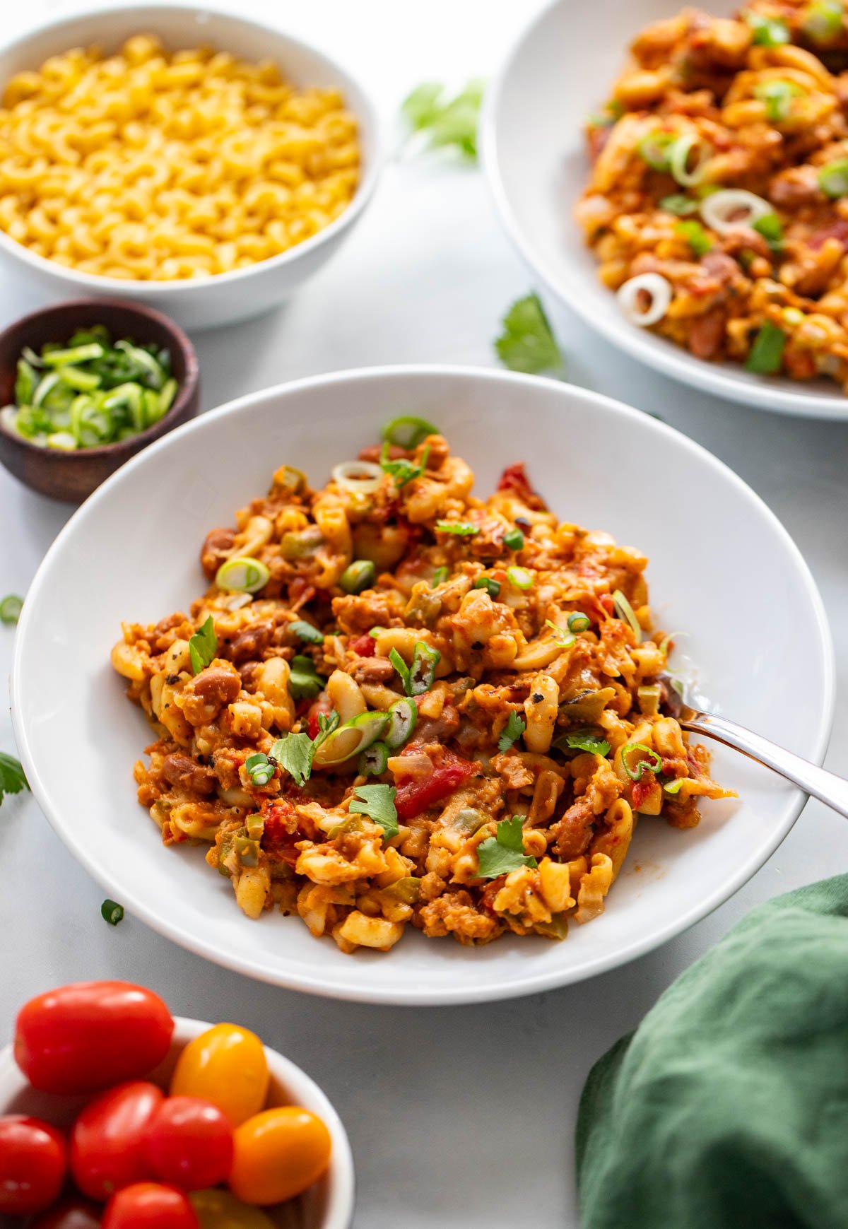 vegan chilli Mac in a white bowl with a spoon.