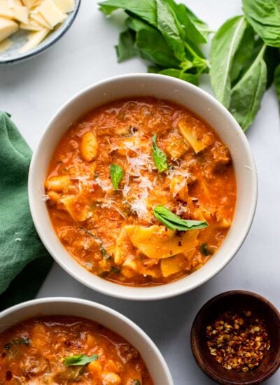 vegan lasagna soup in a bowl garnished with fresh basil.