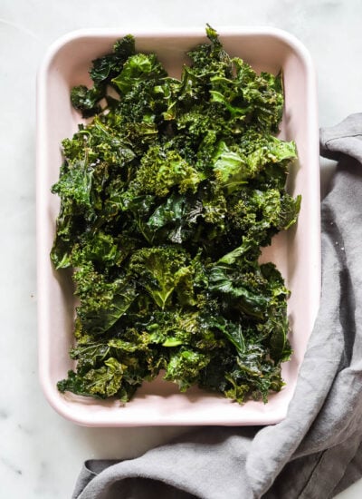 oven baked kale chips in a pink tray.