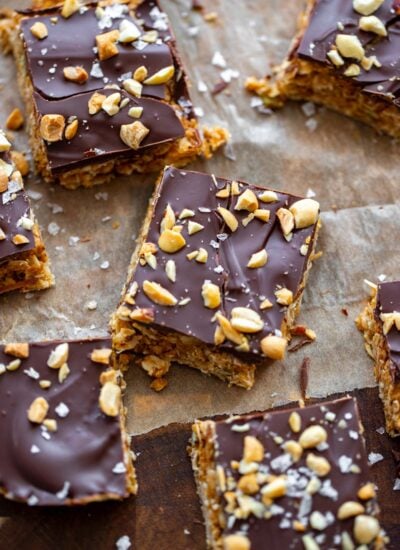 no bake peanut butter oatmeal bars cut into squares on a piece of parchment.