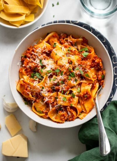 vegan bolognese in a bowl topped with fresh parsley.