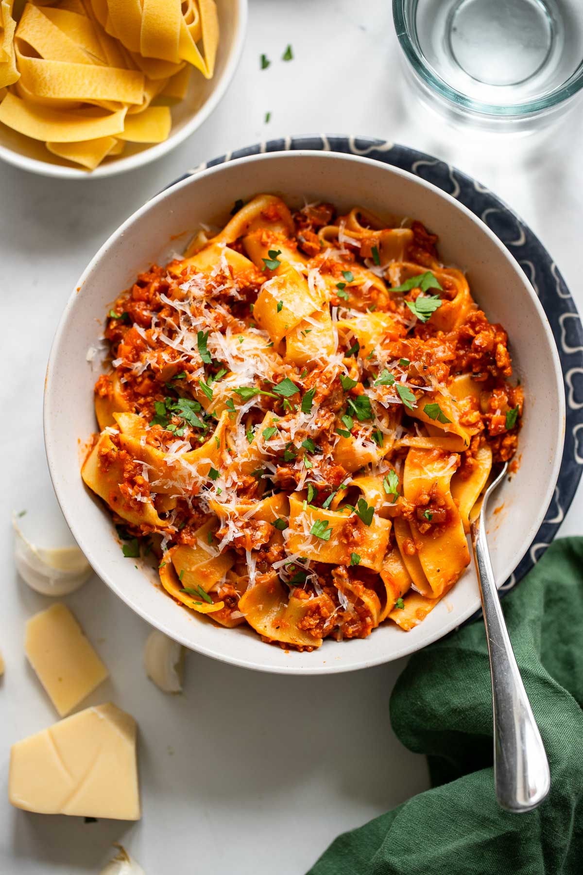 vegetarian bolognese pasta in a bowl topped with fresh chopped parsley.